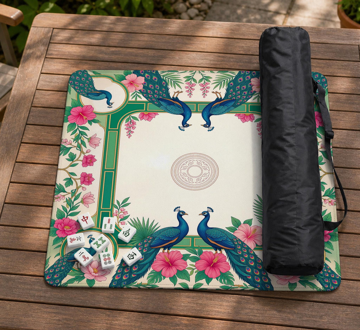 Green mahjong mat with peacocks, hibiscus flowers, tropical leaves, cream center space, and a scalloped floral border.