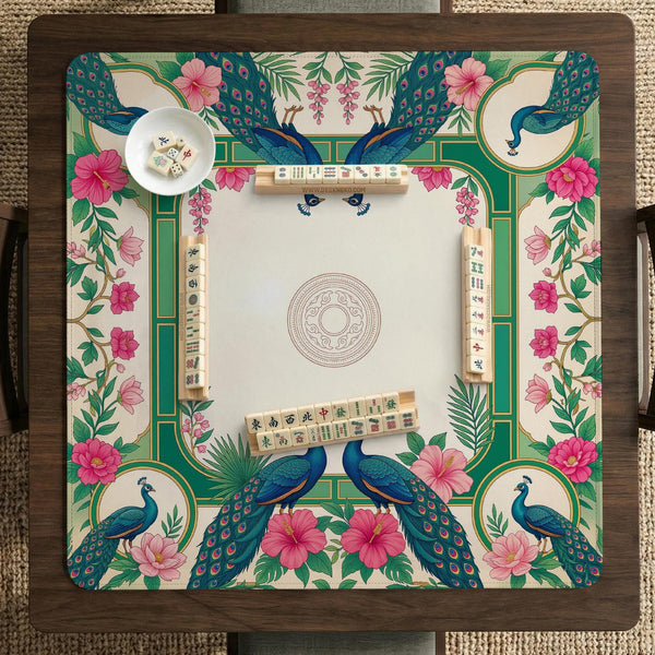 Green mahjong mat with peacocks, hibiscus flowers, tropical leaves, cream center space, and a scalloped floral border.