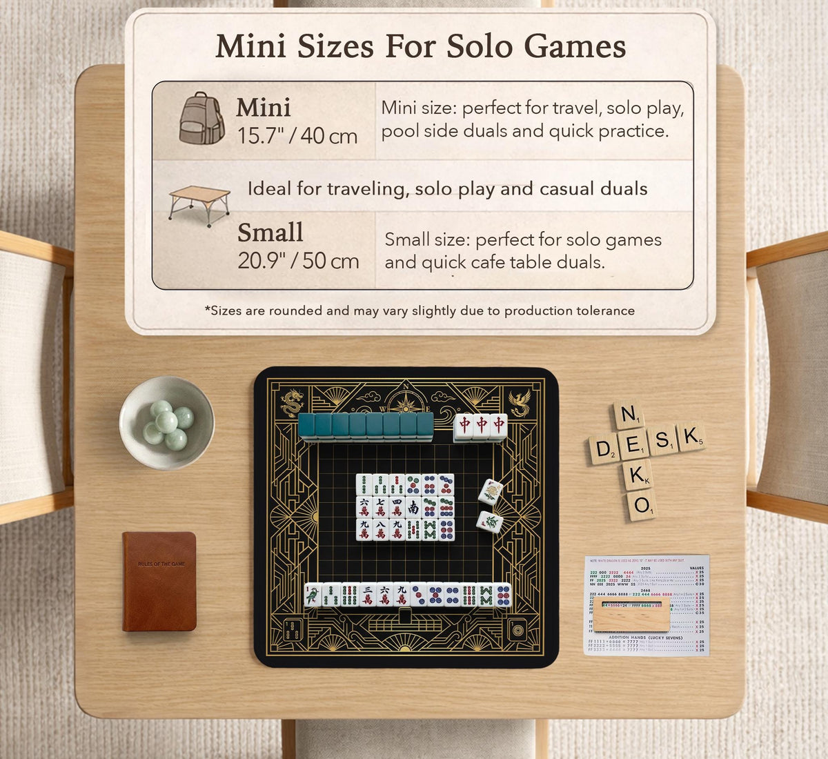 Black and gold square mahjong mat with a scalloped edge, geometric border, thin line details, fan motifs, and dragon and phoenix accents around an open center.