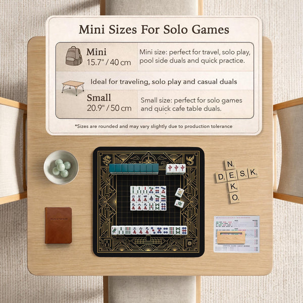 Black and gold square mahjong mat with a scalloped edge, geometric border, thin line details, fan motifs, and dragon and phoenix accents around an open center.