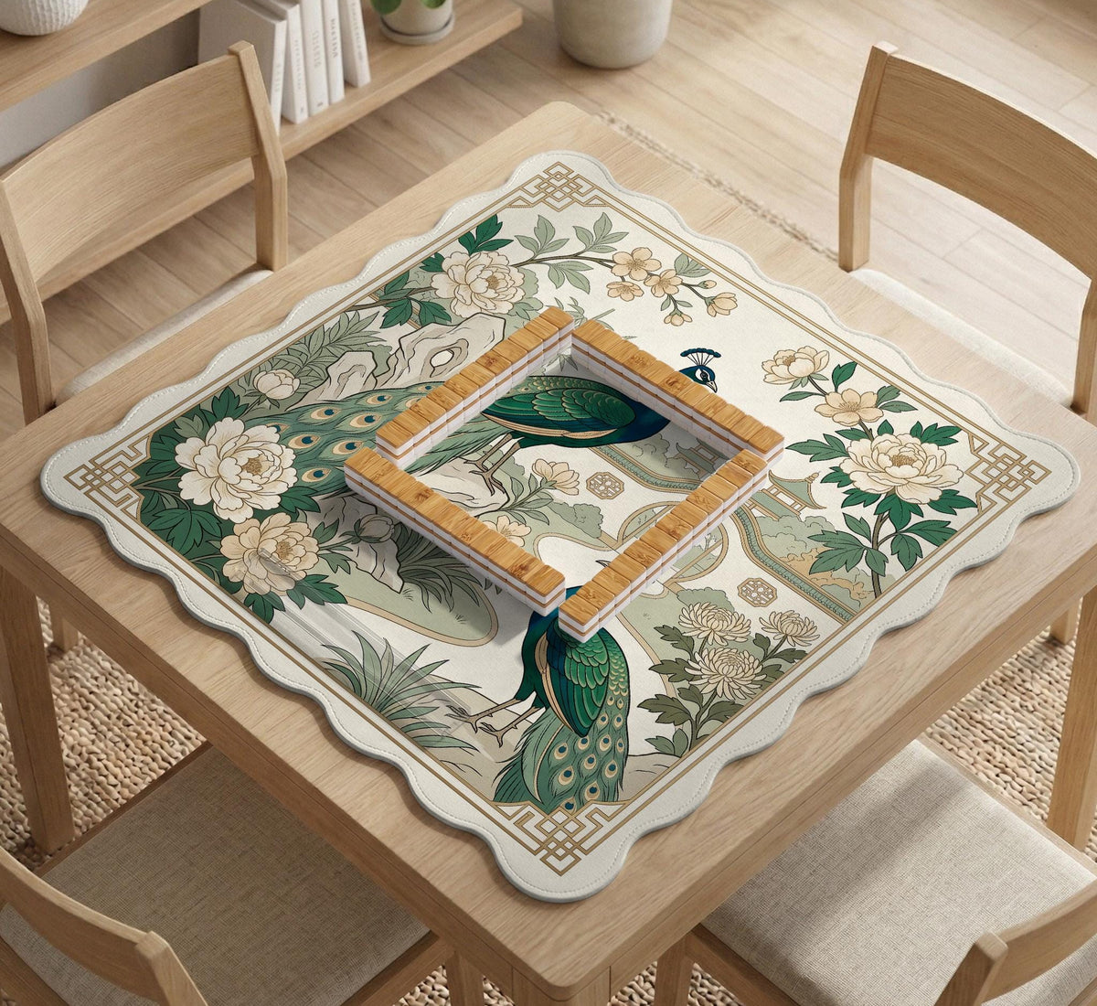 A green mahjong mat with peacock, floral, bamboo, pagoda, and gold border artwork in a scalloped chinoiserie style.
