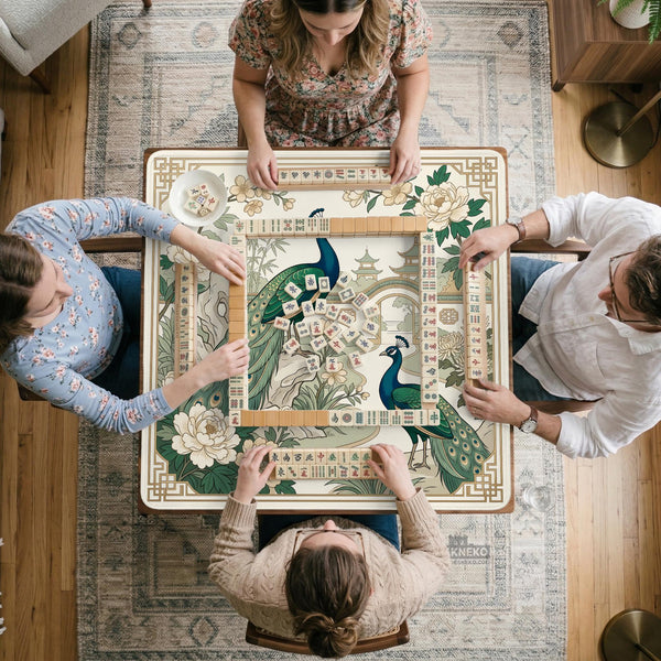 A green mahjong mat with peacock, floral, bamboo, pagoda, and gold border artwork in a scalloped chinoiserie style.