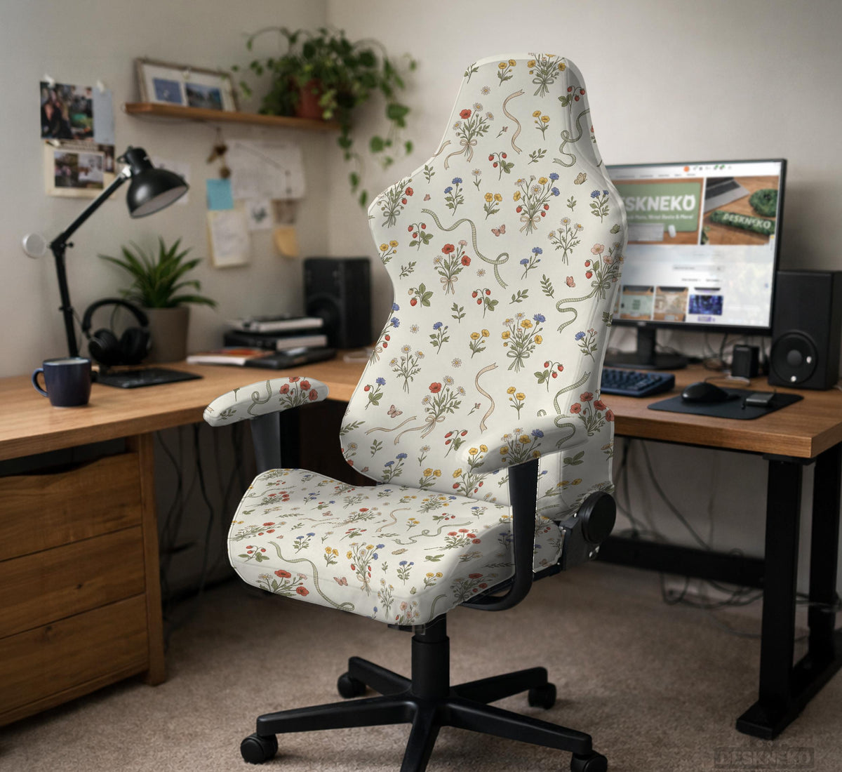 Cream chair cover with a scattered cottage garden floral print in red, blue, yellow, and green on a light background.