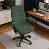 A forest green chair cover with a sage green leaf print shown on a high-back office or gaming chair.