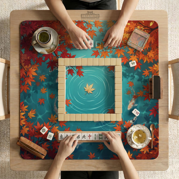 Square teal mahjong mat with koi fish, falling autumn leaves, and pond water artwork.