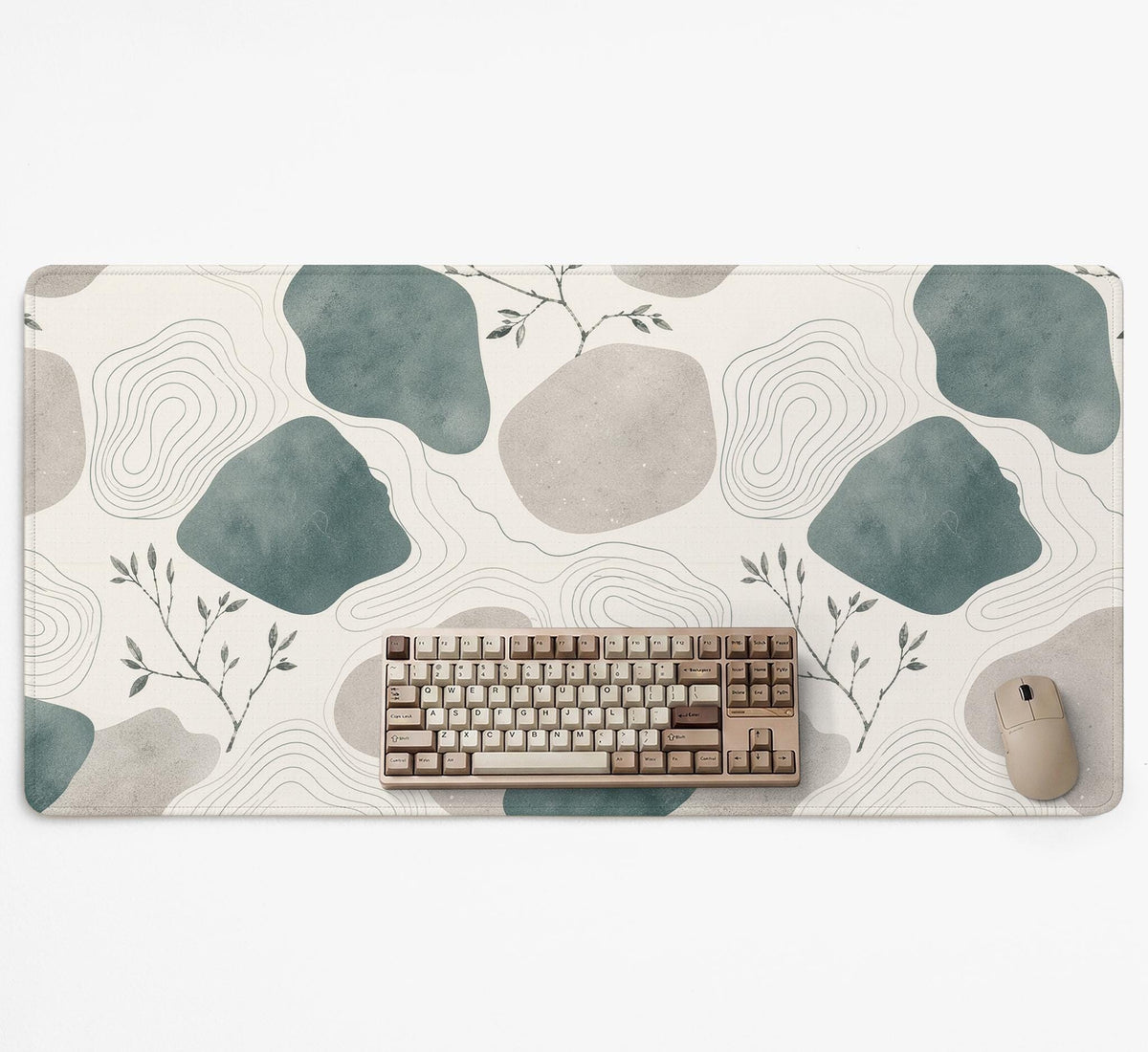 A desk mat with sage green abstract blocks, cream space, gray stone-like shapes, fine topographic contour lines, and small branch details.
