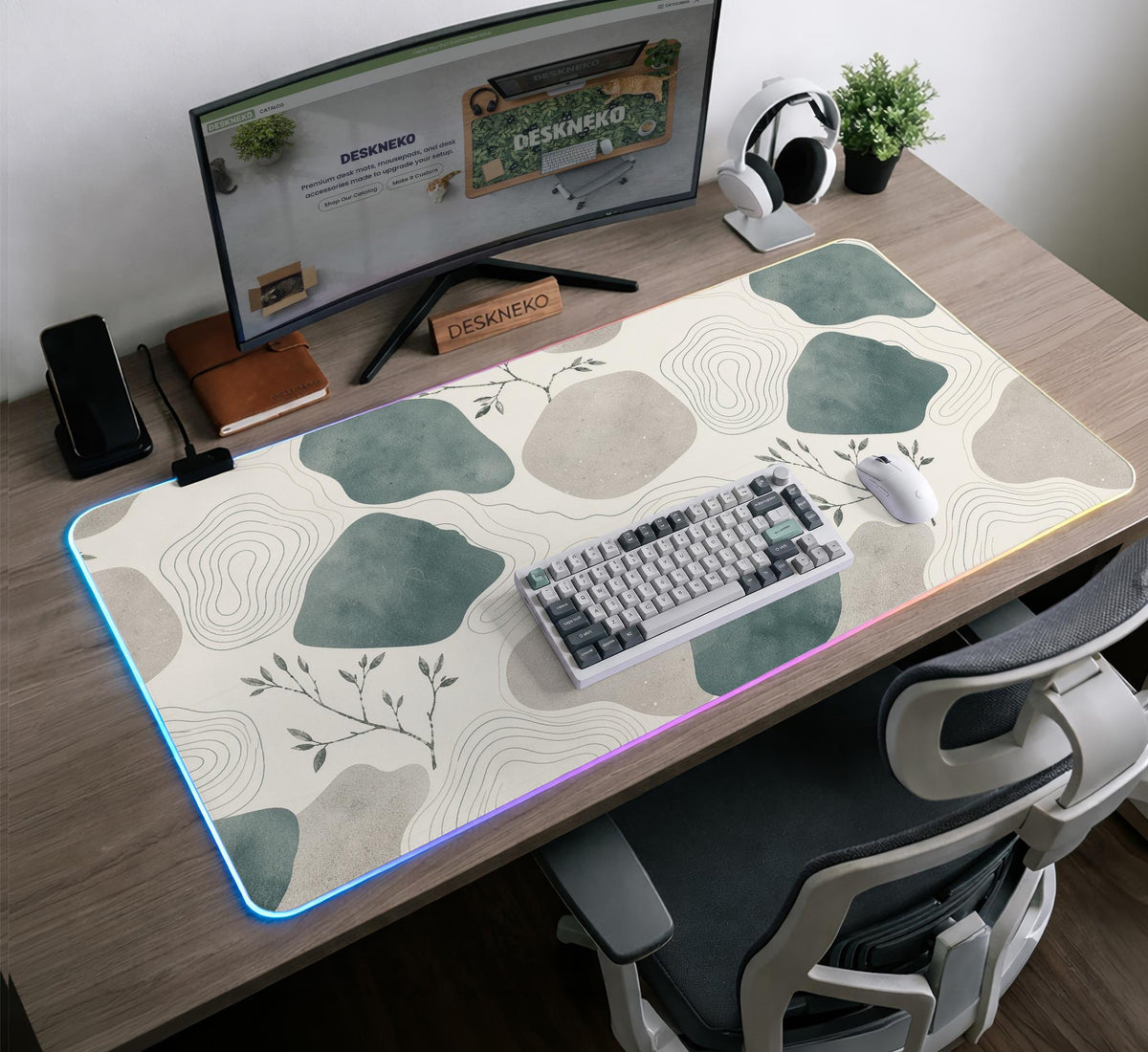 A desk mat with sage green abstract blocks, cream space, gray stone-like shapes, fine topographic contour lines, and small branch details.