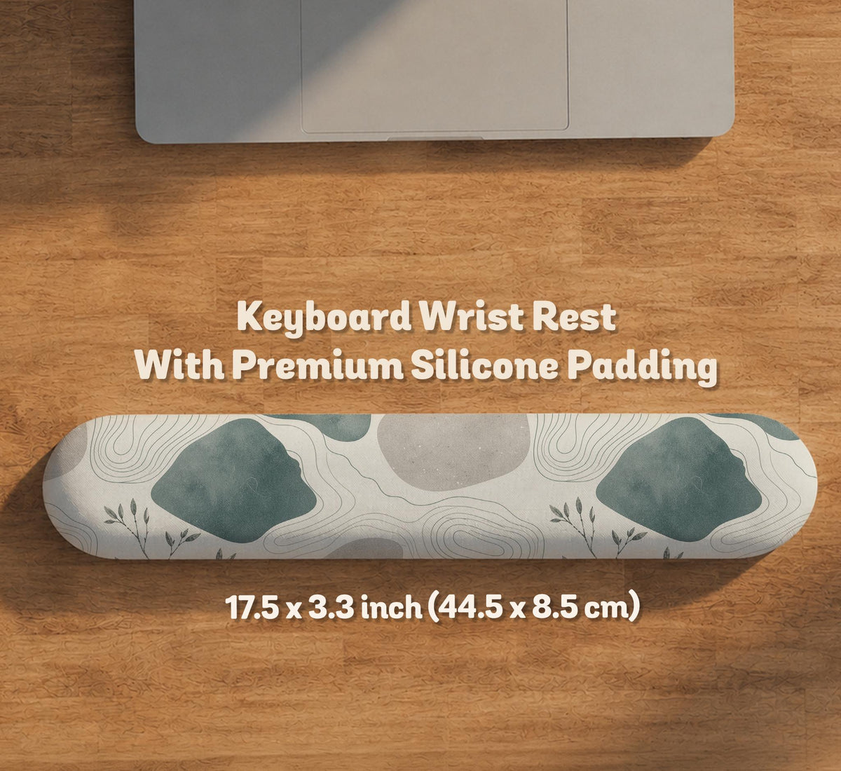 A desk mat with sage green abstract blocks, cream space, gray stone-like shapes, fine topographic contour lines, and small branch details.