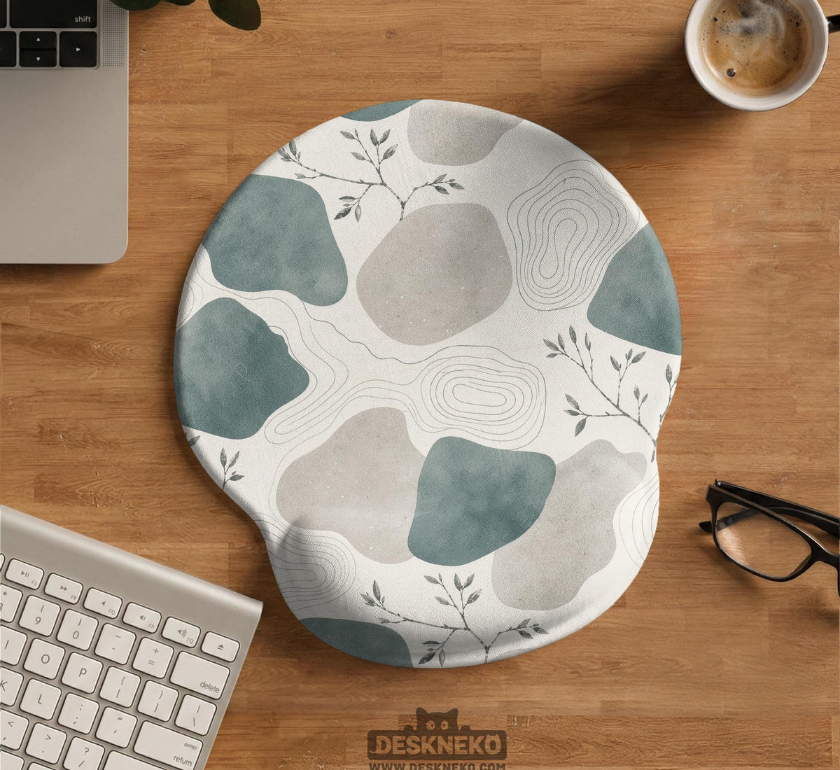 Sage green ergonomic mousepad and keyboard wrist rest with abstract shapes, soft gray details, cream space, topographic contour lines, and leafy branch accents.