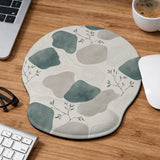 Sage green ergonomic mousepad and keyboard wrist rest with abstract shapes, soft gray details, cream space, topographic contour lines, and leafy branch accents.