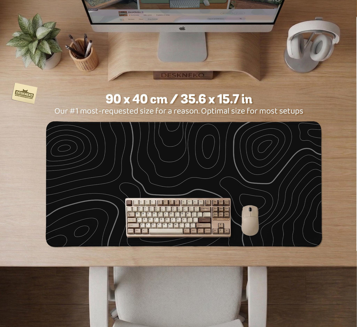 Black desk mat with a thin gray topographic contour line pattern.