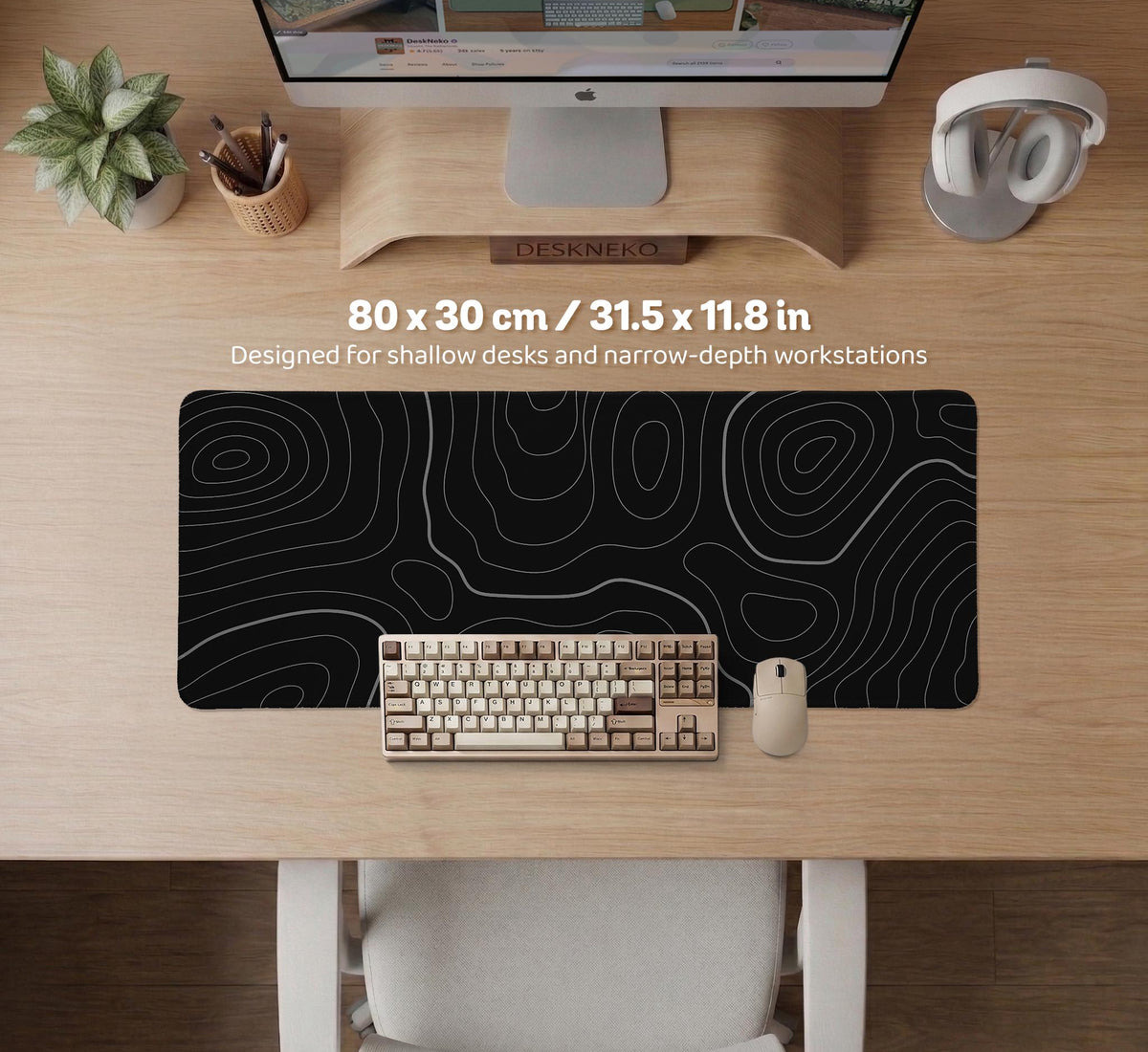 Black desk mat with a thin gray topographic contour line pattern.