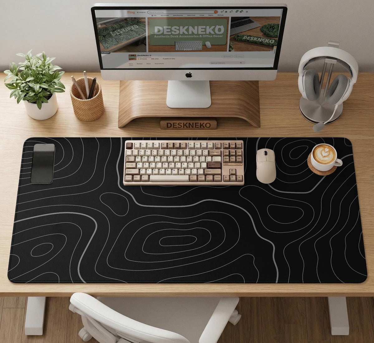 Black desk mat with a thin gray topographic contour line pattern.