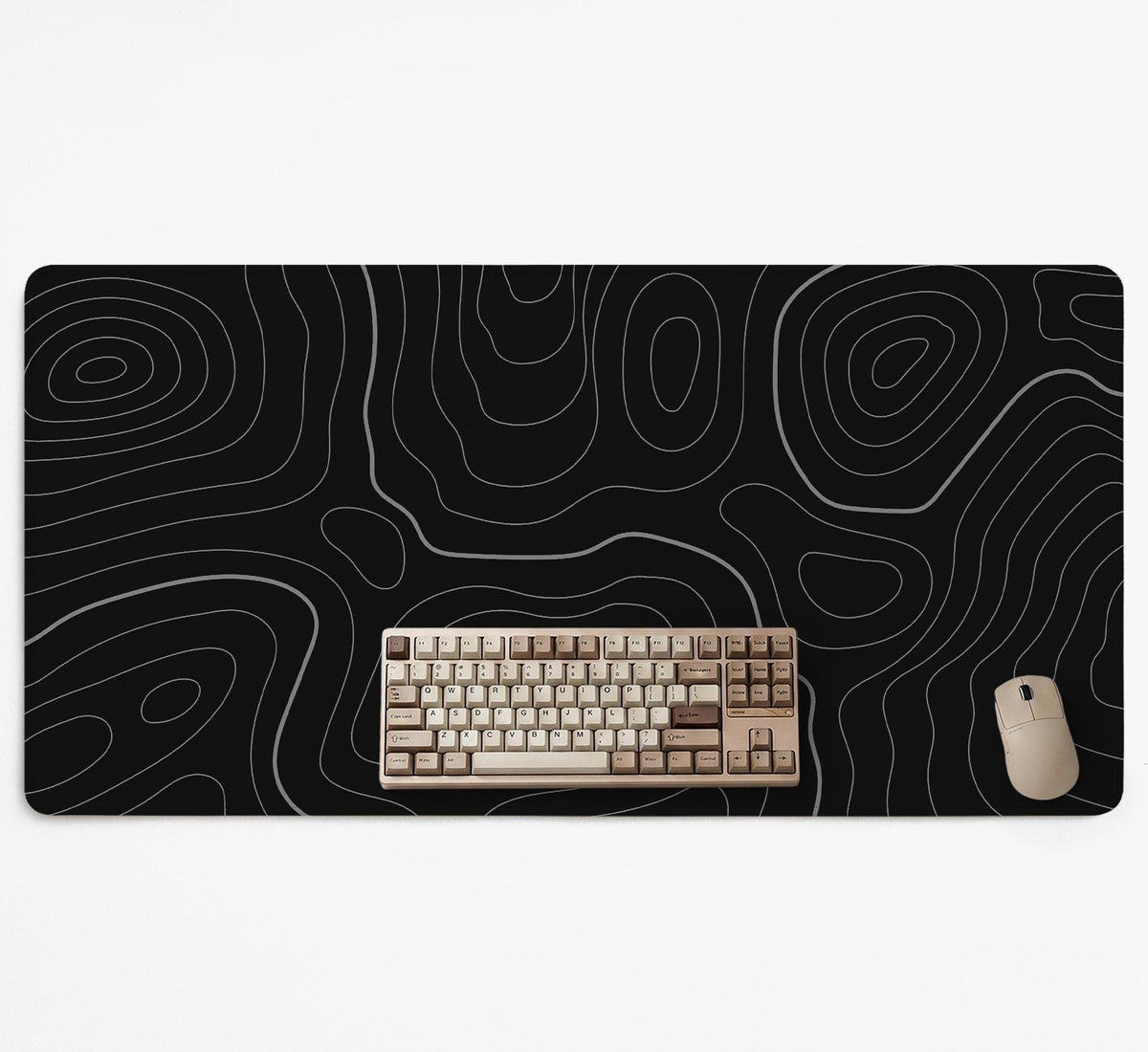 Black desk mat with a thin gray topographic contour line pattern.