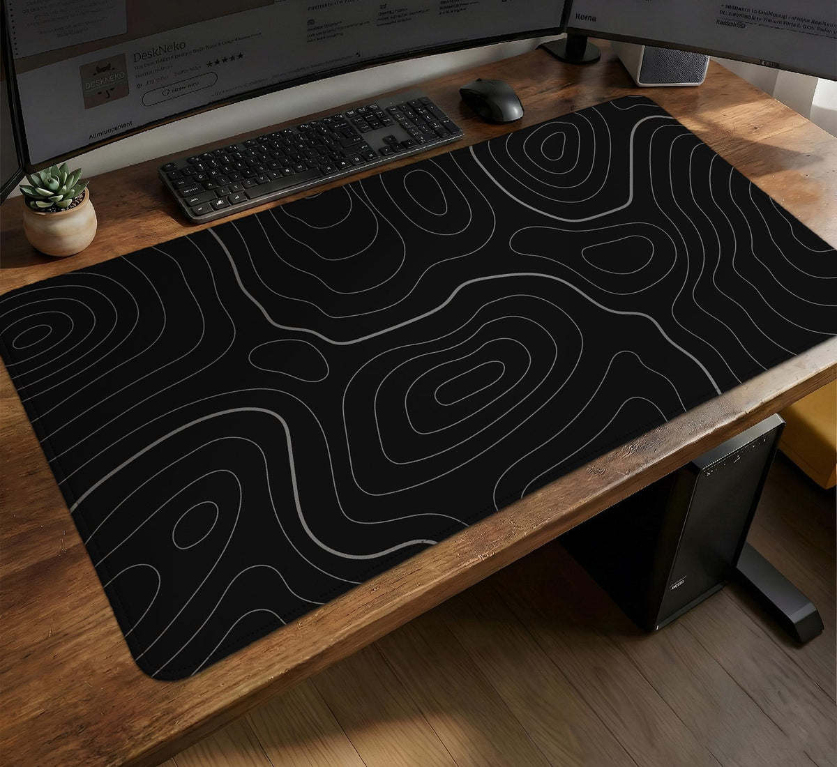 Black desk mat with a thin gray topographic contour line pattern.