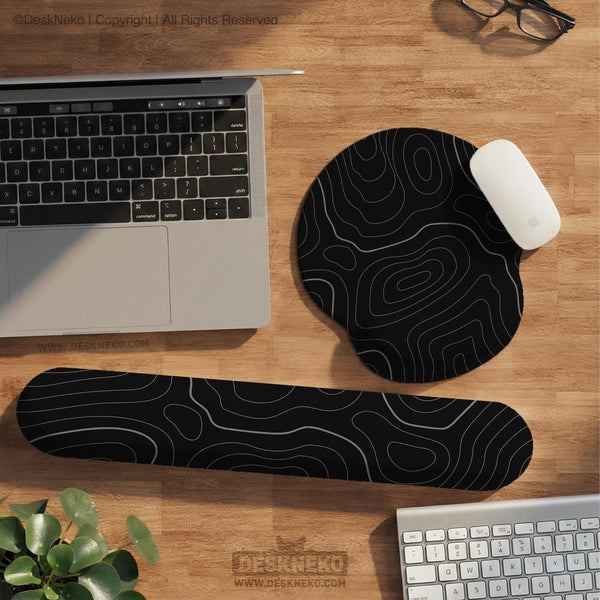 Black mousepad with a gray topographic contour line pattern shown with matching keyboard wrist rest options.