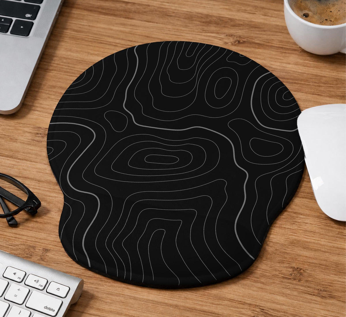 Black mousepad with a gray topographic contour line pattern shown with matching keyboard wrist rest options.