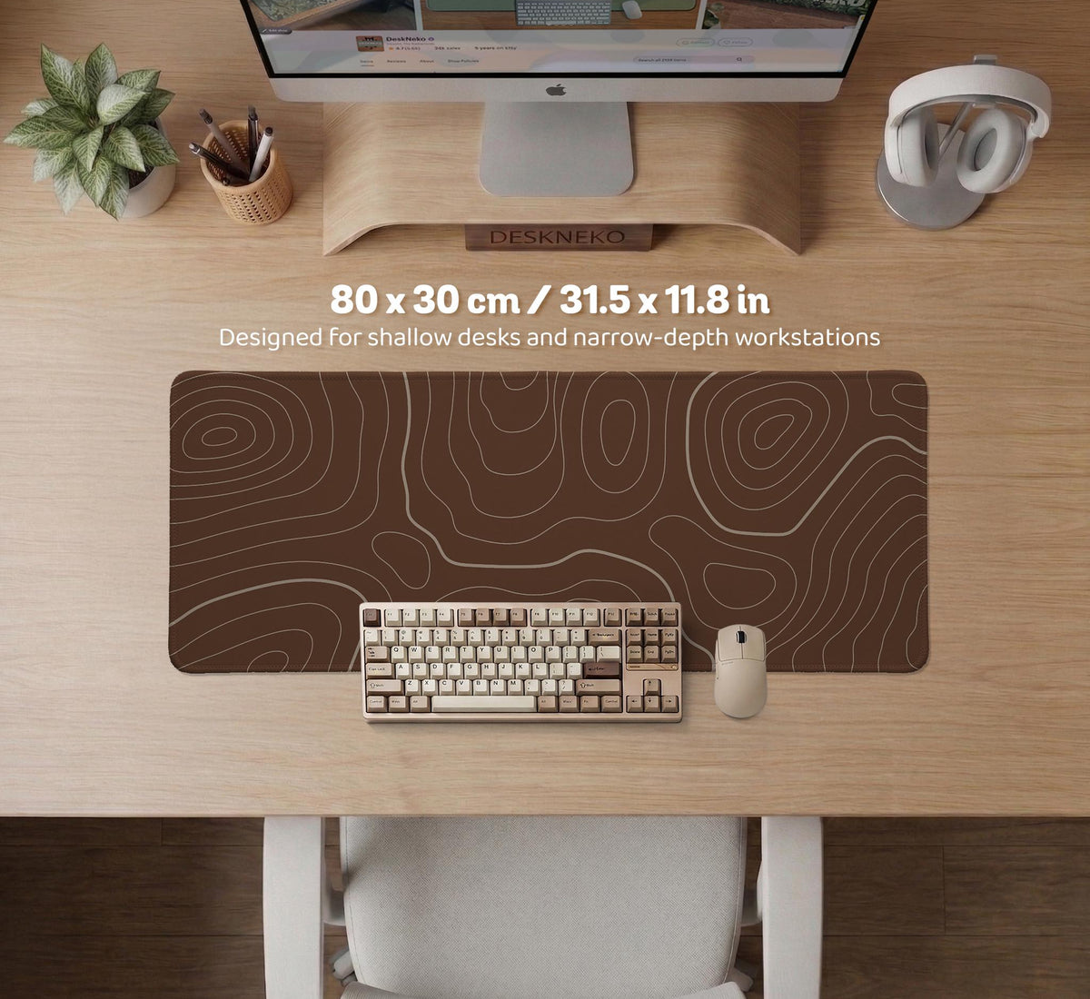 Brown desk mat with a repeating topographic contour line pattern in a neutral earth tone design.
