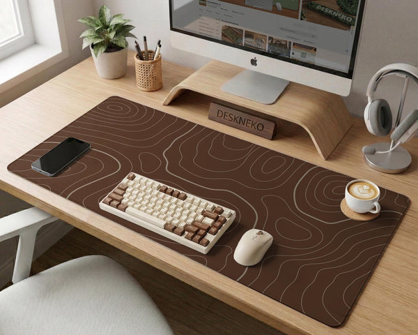 Brown desk mat with a repeating topographic contour line pattern in a neutral earth tone design.