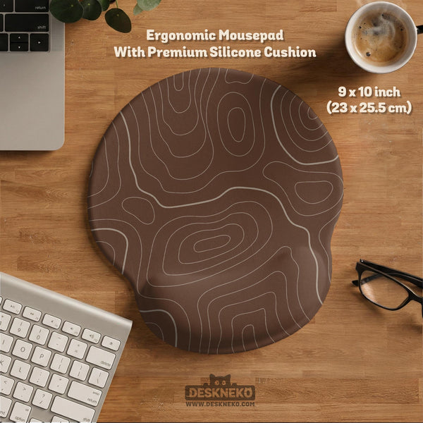 Brown desk mat with a repeating topographic contour line pattern in a neutral earth tone design.
