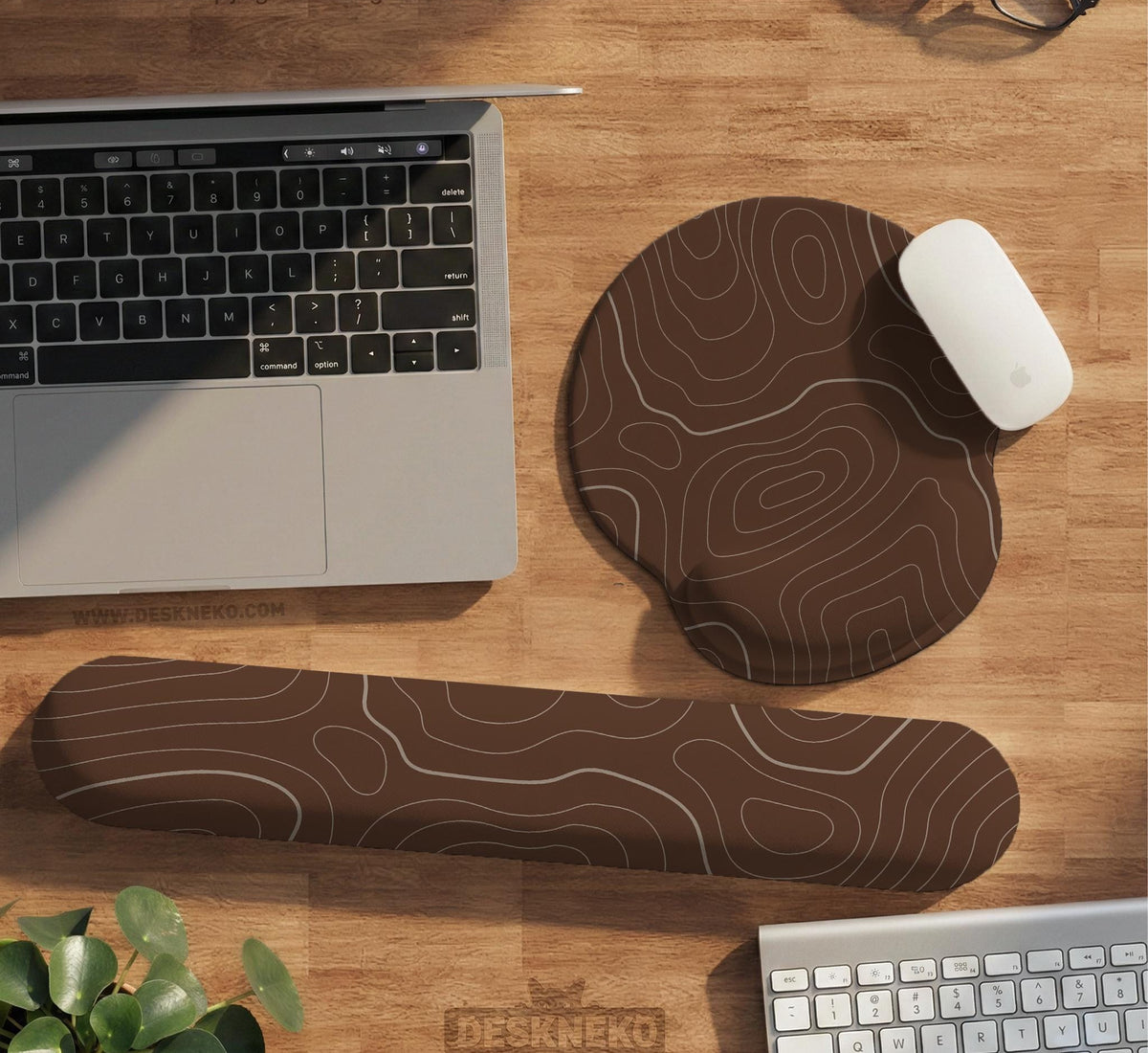 Brown mousepad and keyboard wrist rest with a topographic contour-line pattern.