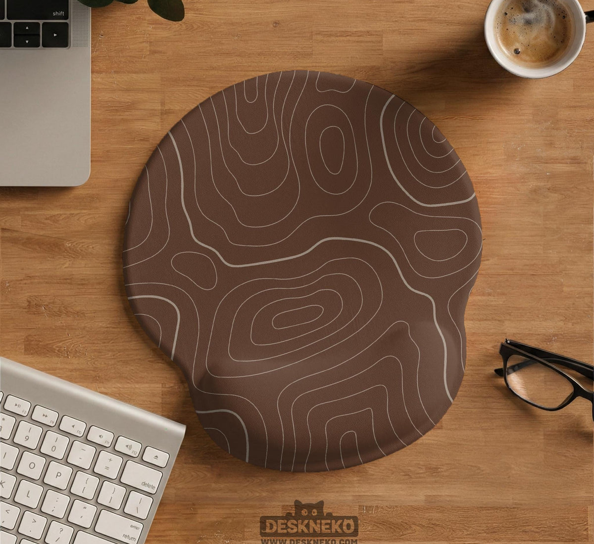 Brown mousepad and keyboard wrist rest with a topographic contour-line pattern.
