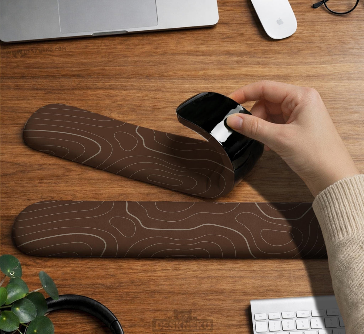 Brown mousepad and keyboard wrist rest with a topographic contour-line pattern.