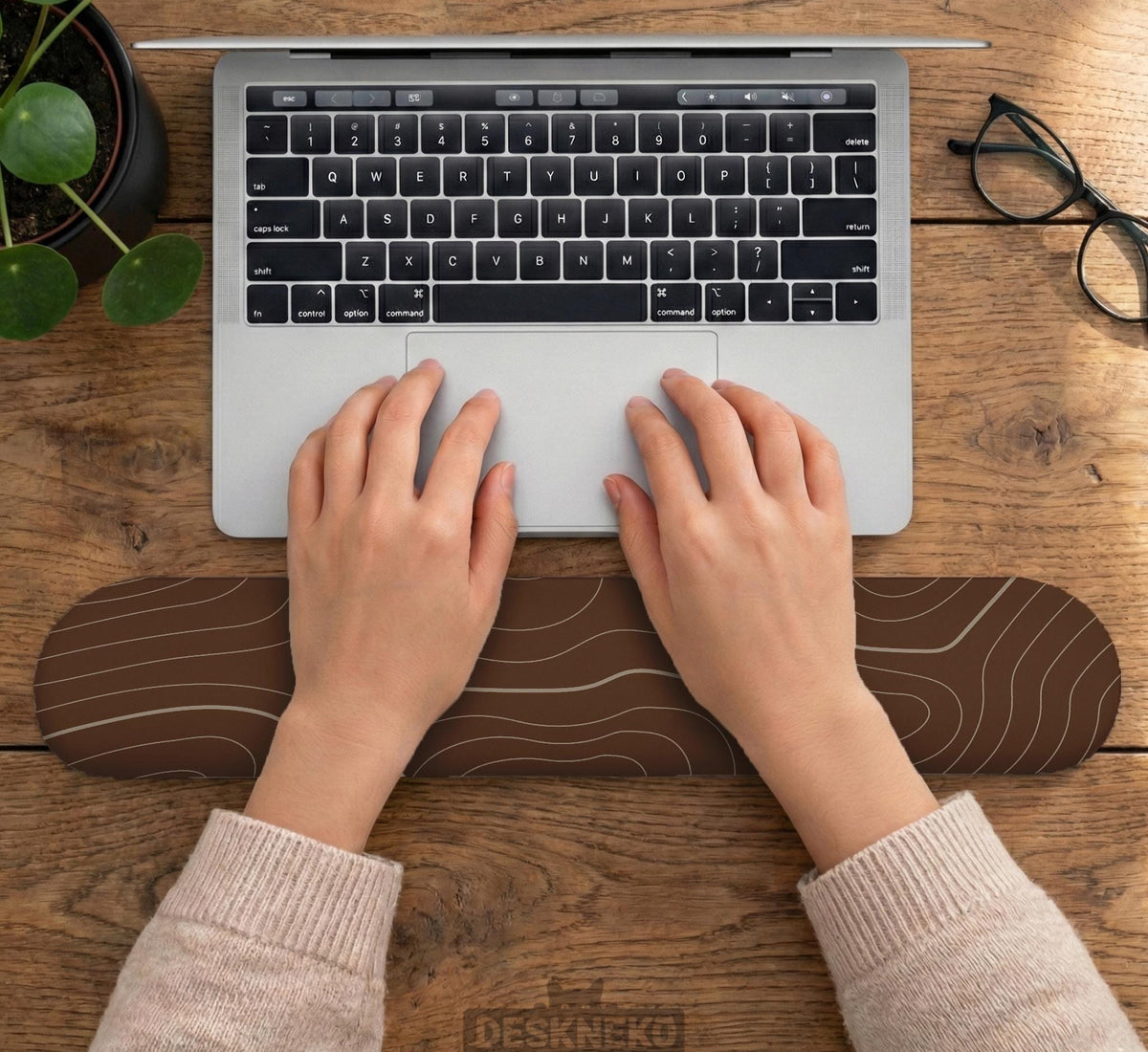 Brown mousepad and keyboard wrist rest with a topographic contour-line pattern.