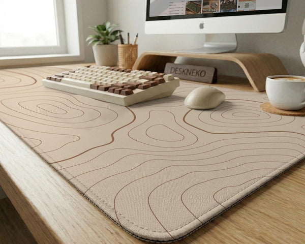 A beige mousepad with a topographic line pattern in a repeating design.
