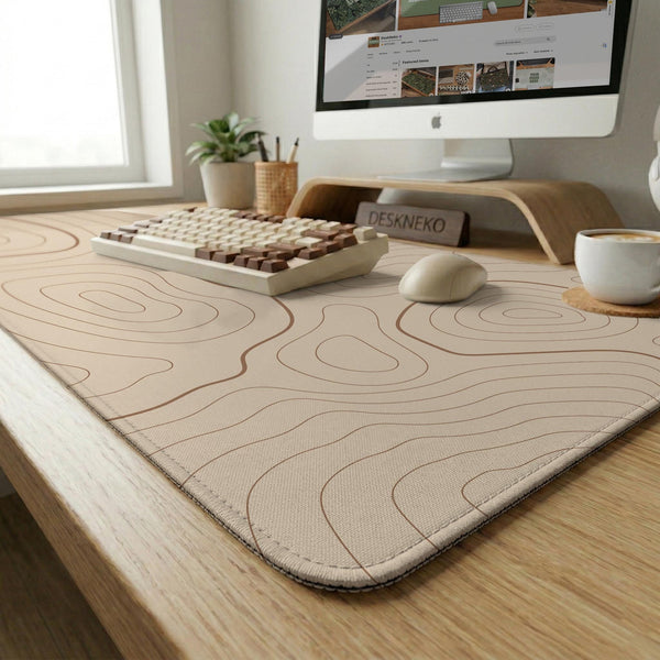 A beige mousepad with a topographic line pattern in a repeating design.