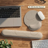 Beige mousepad and keyboard wrist rest with a topographic line pattern shown in a neutral desk setup.