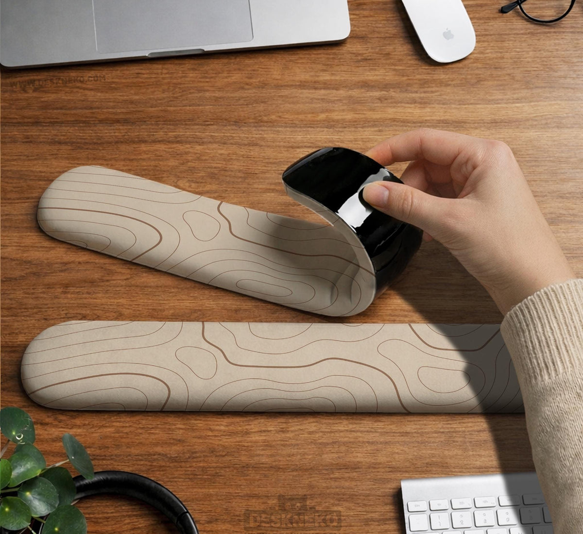 Beige mousepad and keyboard wrist rest with a topographic line pattern shown in a neutral desk setup.