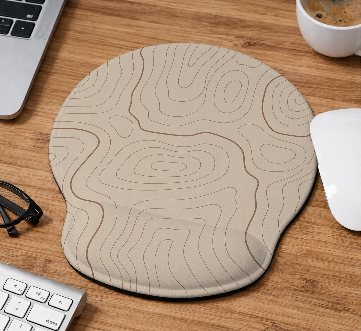 Beige mousepad and keyboard wrist rest with a topographic line pattern shown in a neutral desk setup.