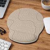 Beige mousepad and keyboard wrist rest with a topographic line pattern shown in a neutral desk setup.