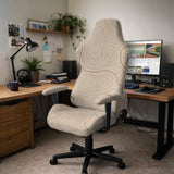 Beige desk chair cover with a topographic line art pattern shown on a chair, with examples of full chair cover, back and seat cover, seat-only cover, and armrest-only cover options.