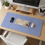A periwinkle deskmat with thin blue contour lines printed across the surface.