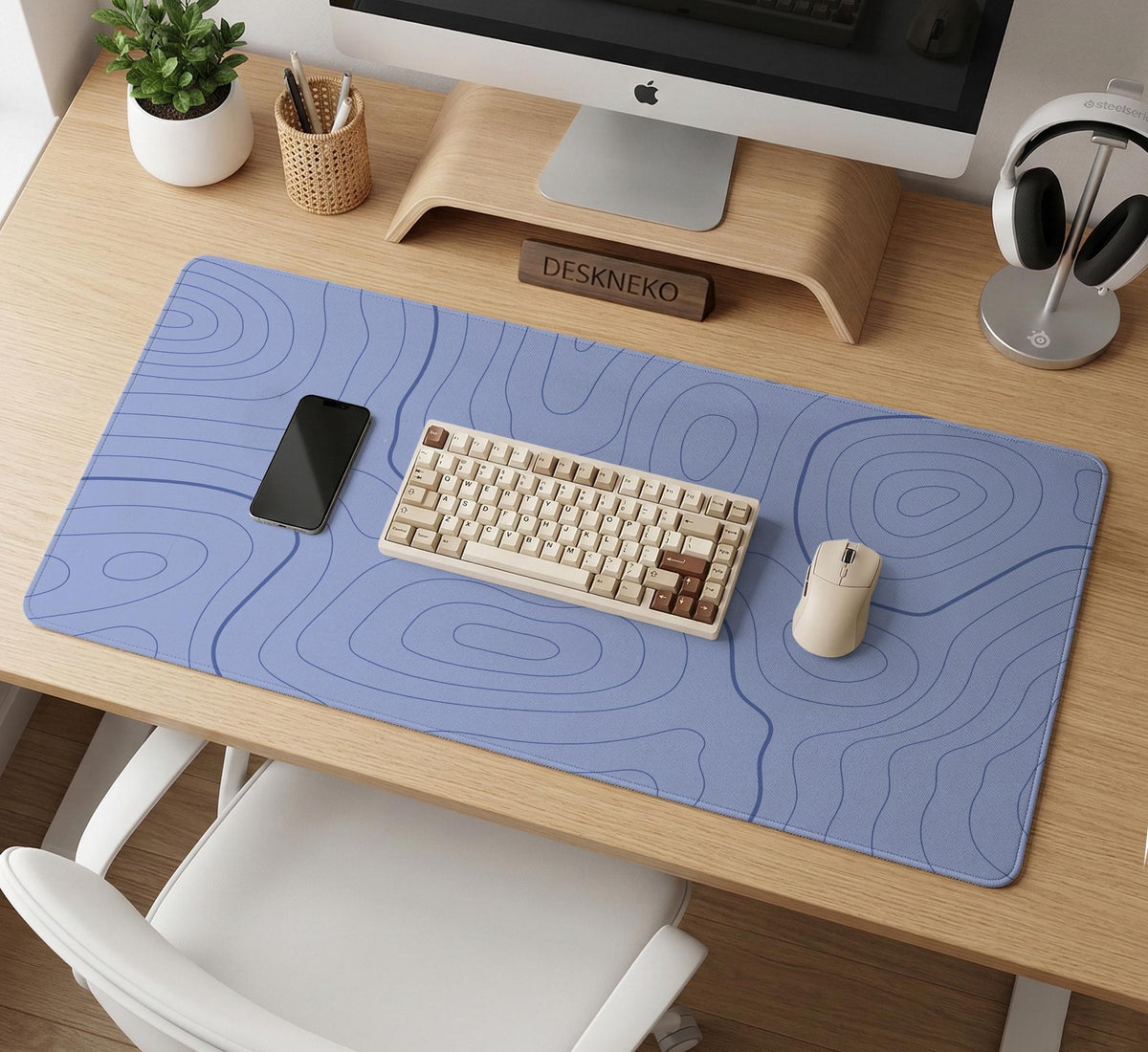 A pastel blue mousepad with an abstract topographic contour line pattern.