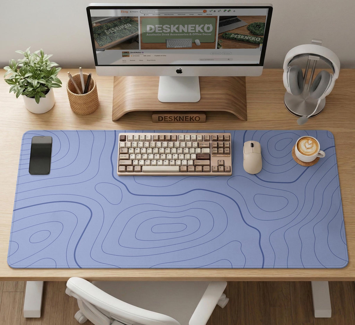 A pastel blue mousepad with an abstract topographic contour line pattern.