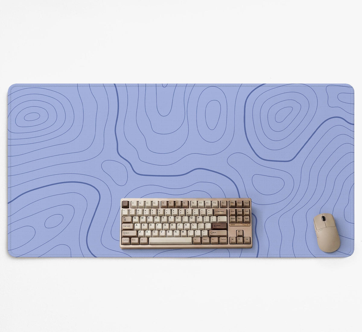 A periwinkle deskmat with thin blue contour lines printed across the surface.
