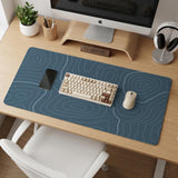 Blue mousepad with a topographic line pattern on a slate background.