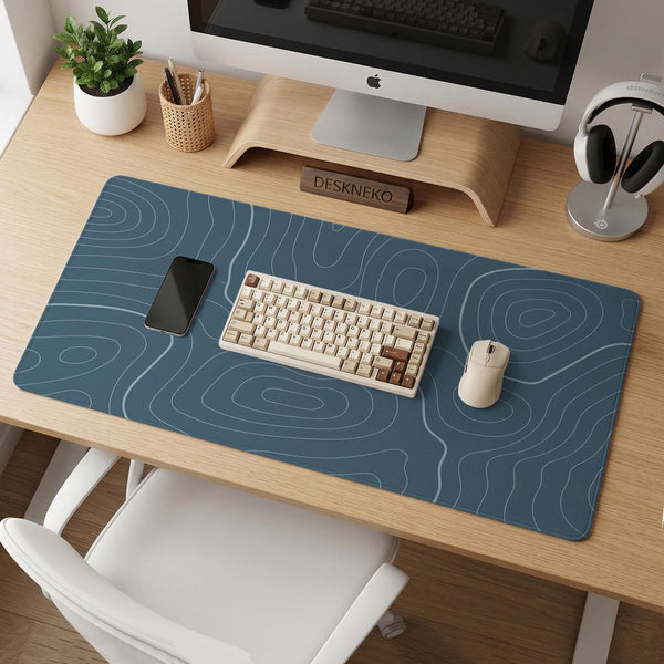 Blue mousepad with a topographic line pattern on a slate background.