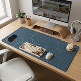 Blue mousepad with a topographic line pattern on a slate background.