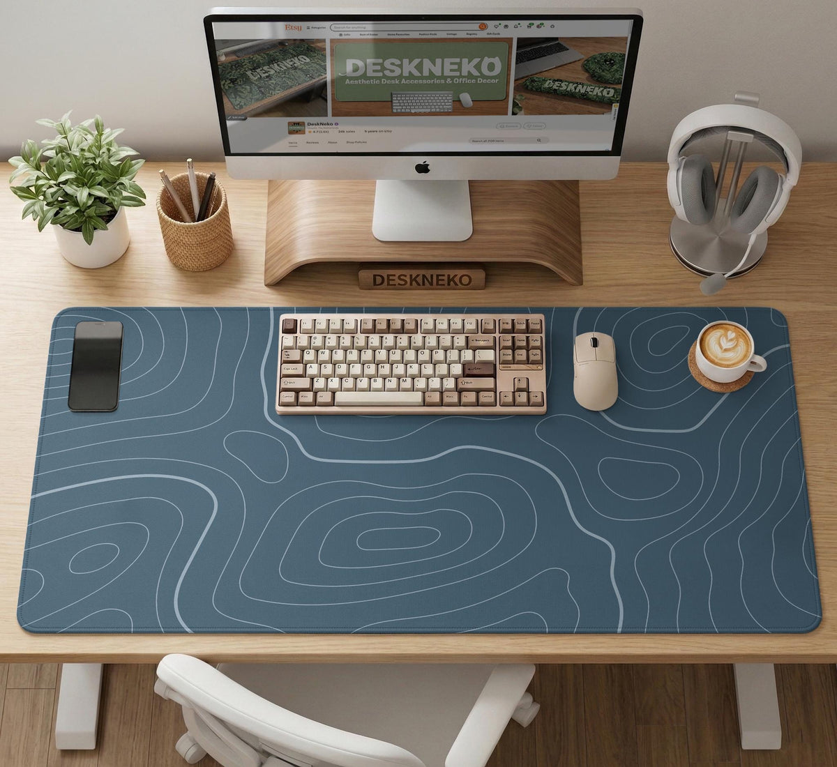 Blue mousepad with a topographic line pattern on a slate background.