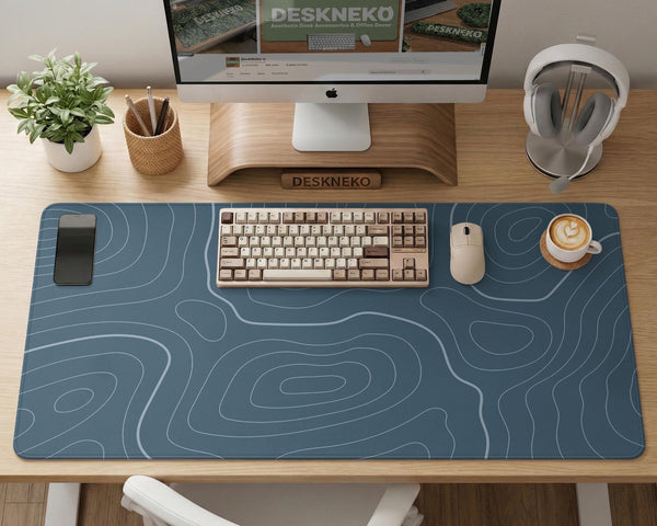 Blue mousepad with a topographic line pattern on a slate background.