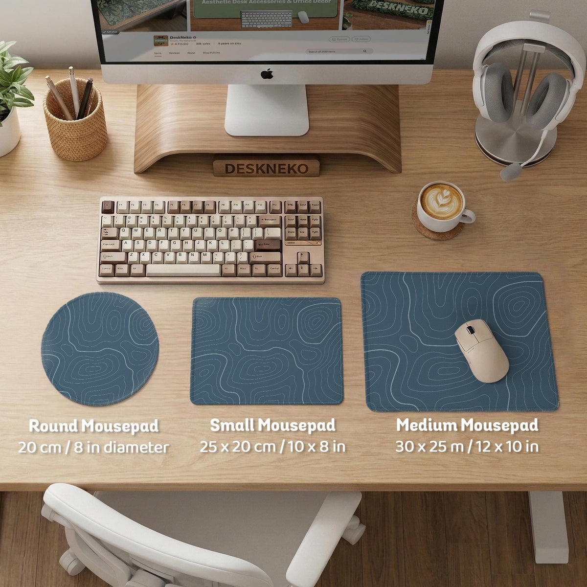 A slate blue desk mat with thin contour line map art on a light background.