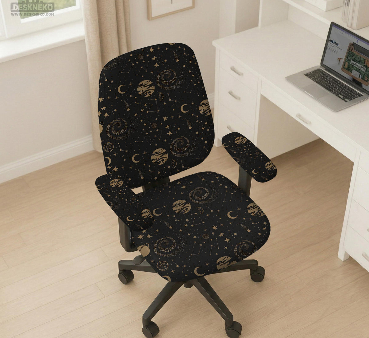 Black chair cover with a dark galaxy pattern, muted gold stars and celestial artwork on a chair.