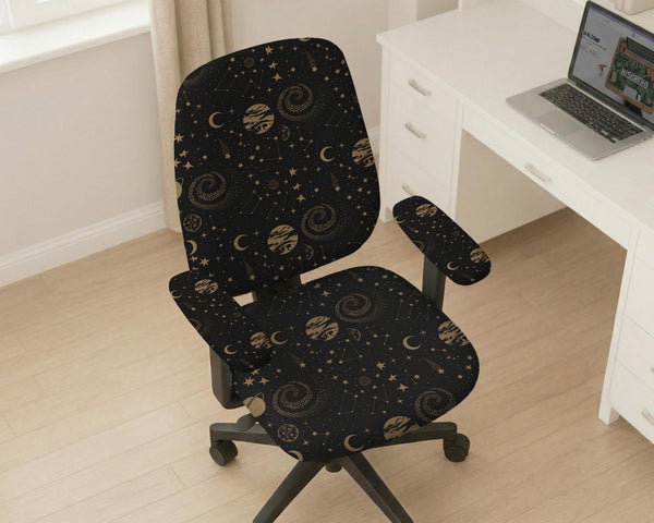 Black chair cover with a dark galaxy pattern, muted gold stars and celestial artwork on a chair.