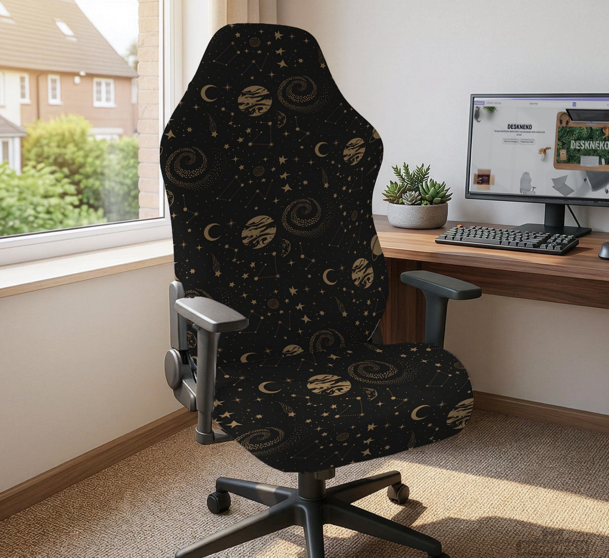 Black chair cover with a dark galaxy pattern, muted gold stars and celestial artwork on a chair.