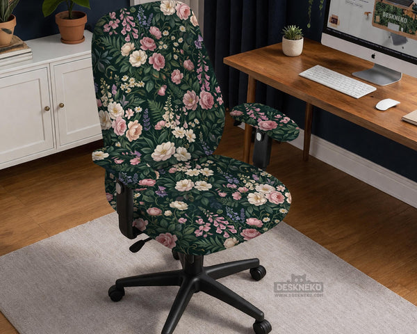 Green chair cover with a dark floral pattern, pink roses, cream flowers, and leafy botanical details on an office chair.