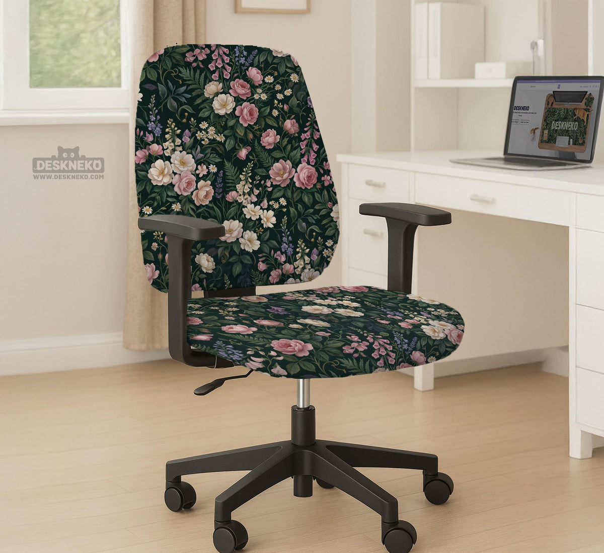 Green chair cover with a dark floral pattern, pink roses, cream flowers, and leafy botanical details on an office chair.